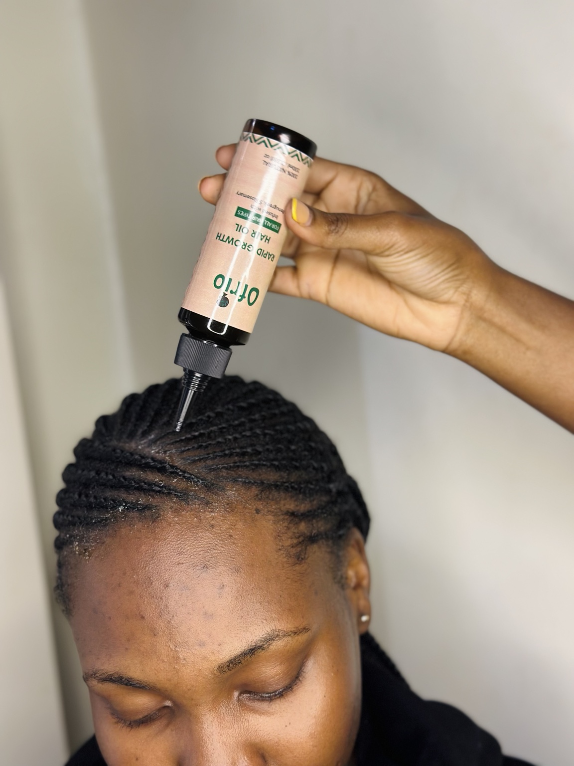 Ofrio oil being applied directly to textured hair